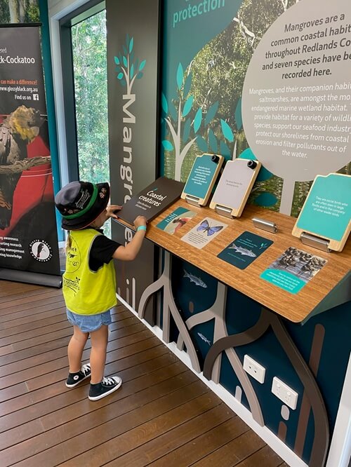 Little Scholars Student In A Safety Vest Exploring An Exhibit During A Field Trip.