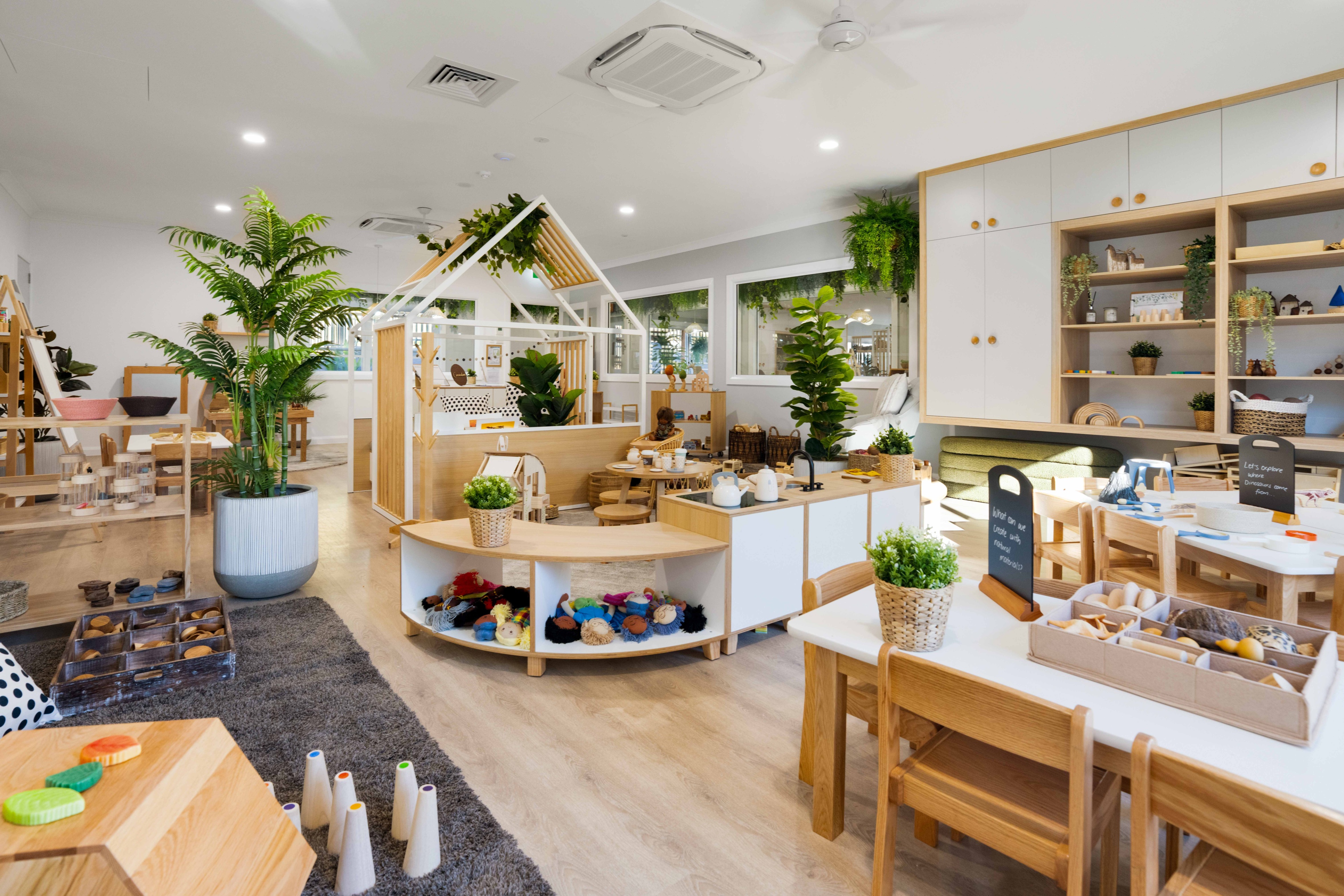 Spacious indoor play and study area at Little Scholar's Karalee Child Care Centre with natural surroundings and modern play equipment.