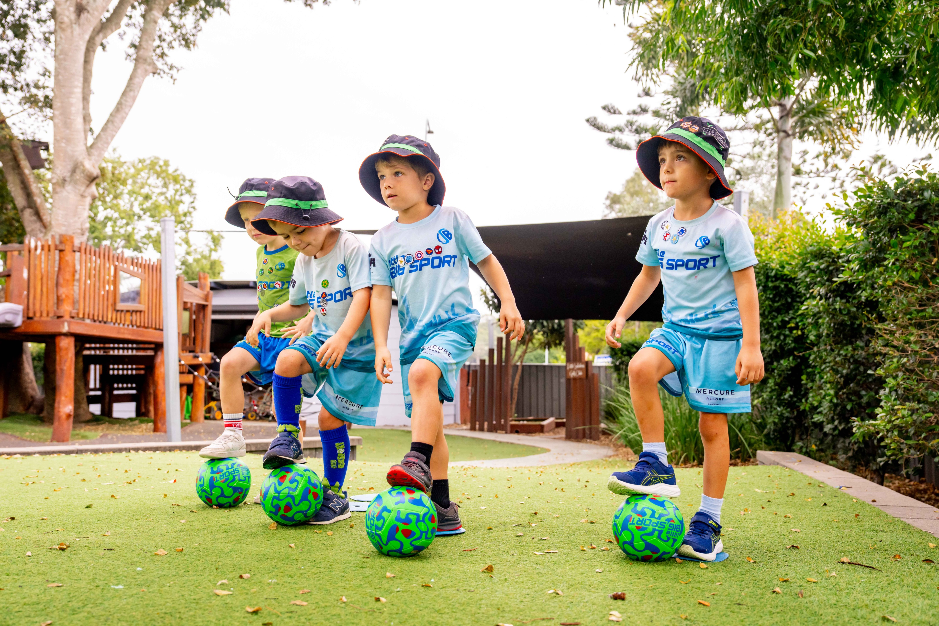 Preschool-aged children practicing soccer skills during sport in early childhood education.
