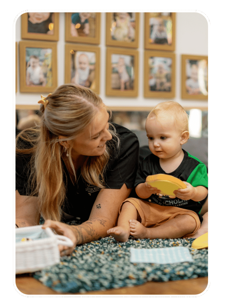 Early Childhood Educator Engaging In Play Based Learning With Toddler