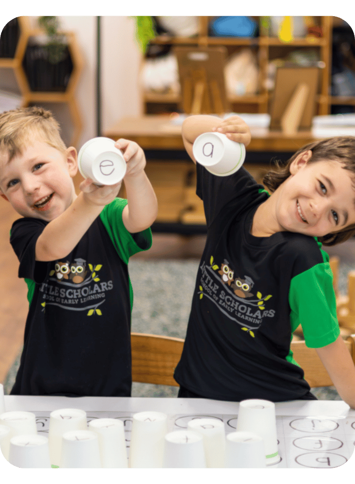 Happy Little Scholars Playing Cups With Letters