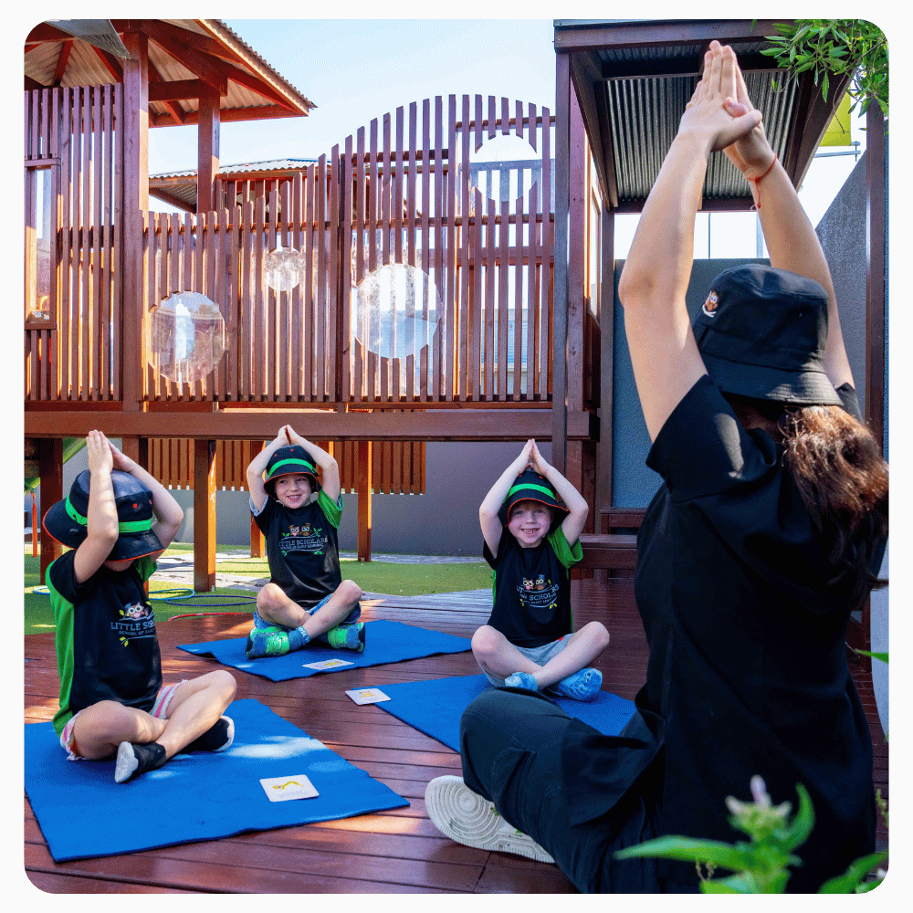 Little Scholars Doing Exercise And Yoga With Educator Outdoors