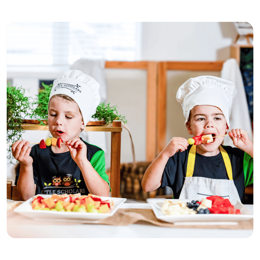 Two Little Scholars Kids Eating Fruits